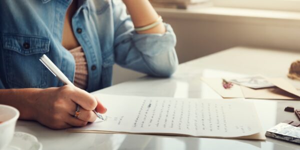 Caucasian woman writing a letter