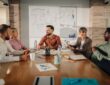 Marketing professionals collaborating on project during meeting