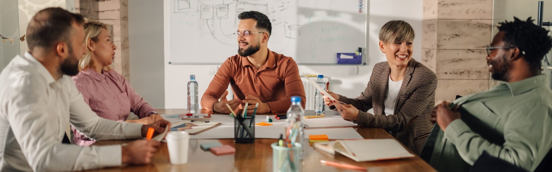 Marketing professionals collaborating on project during meeting