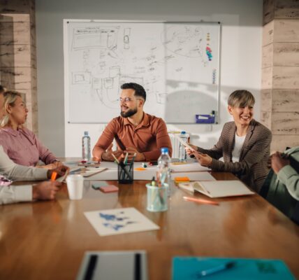 Marketing professionals collaborating on project during meeting