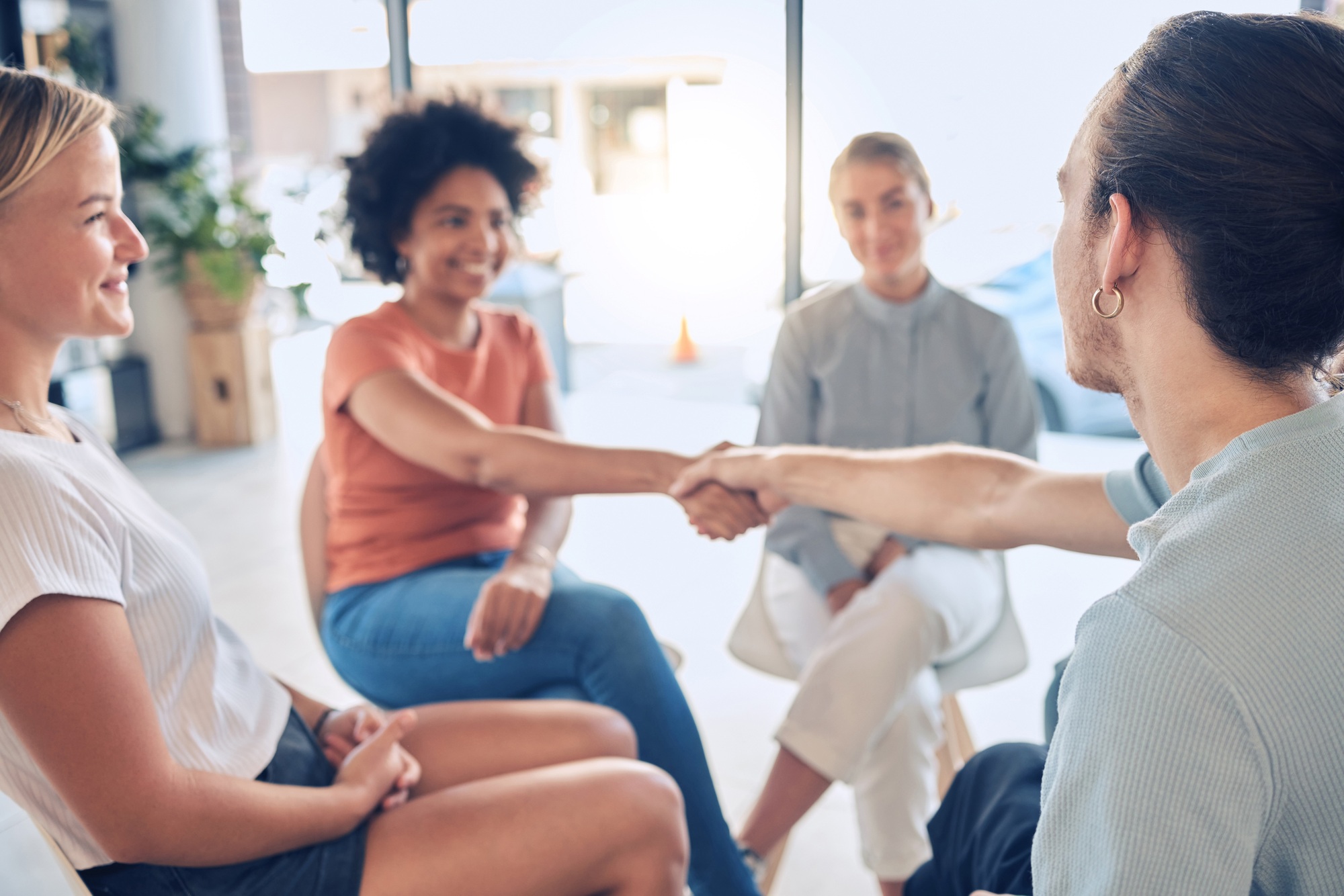 Welcome, handshake and people in counseling for mental health, coping and stress management with su